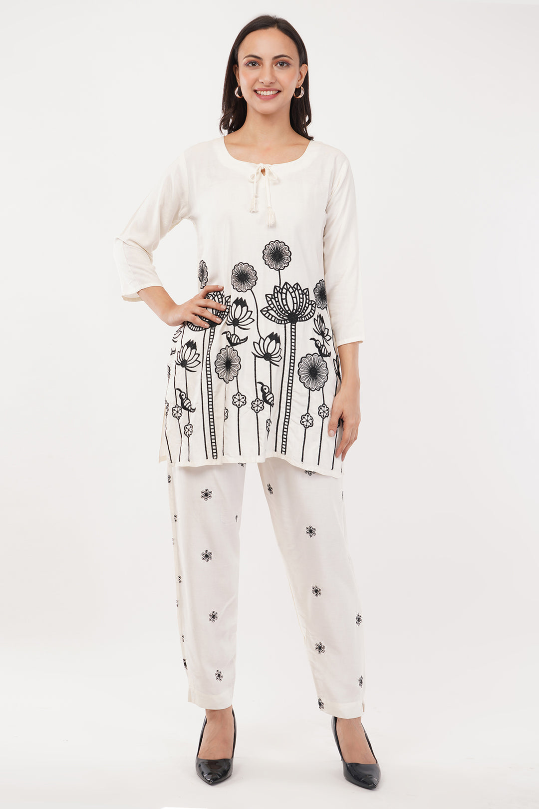 offwhite cord set with black work on the pants