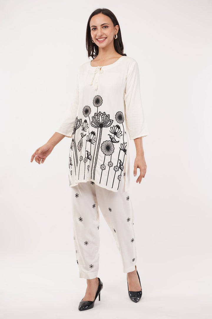 offwhite cord set with black work on the pants