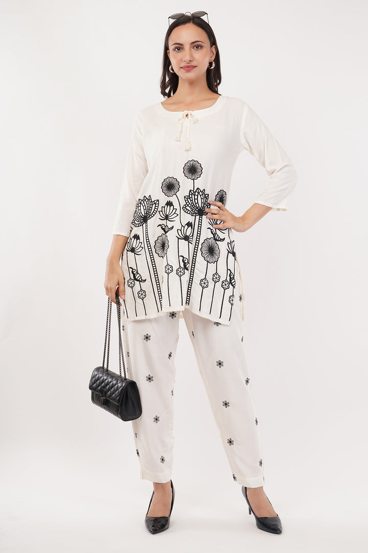 offwhite cord set with black work on the pants